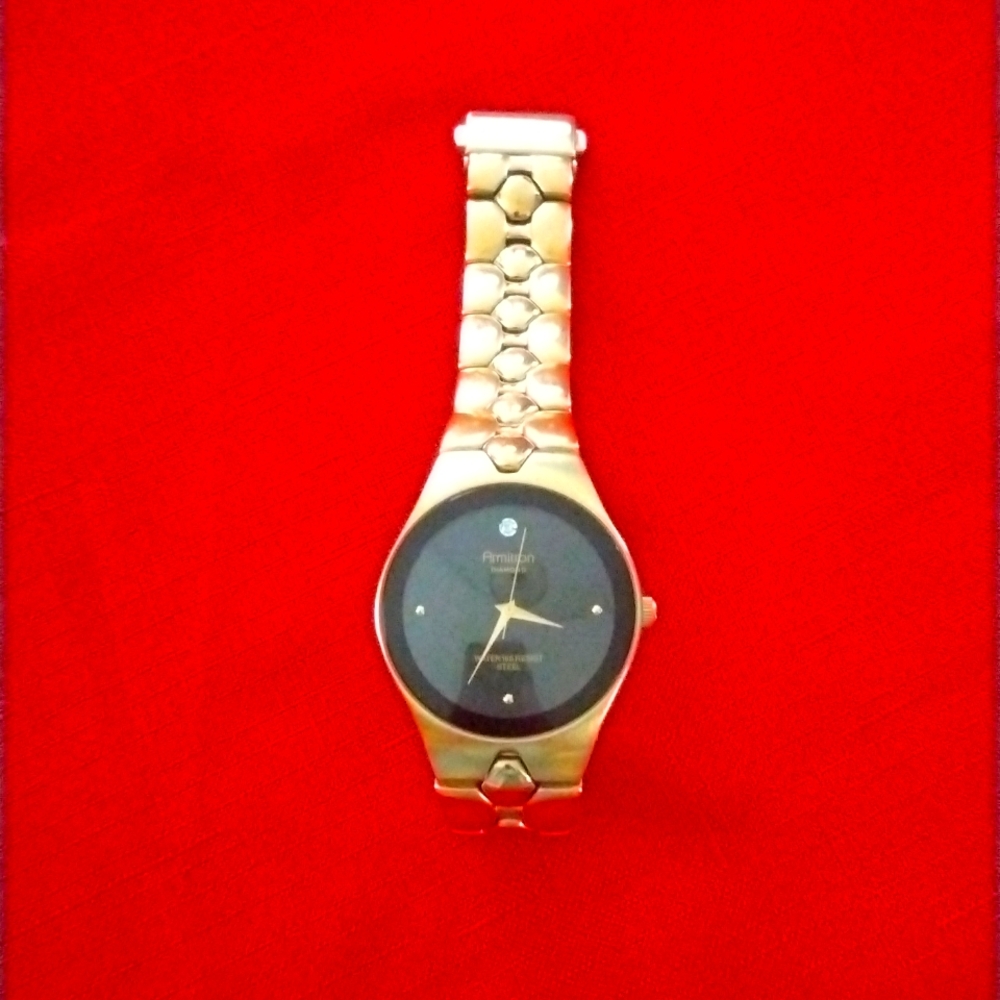 I am selling an armington gold watch with diamonds and a black backdrop face